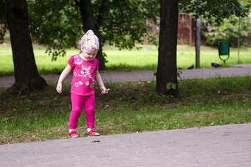 Fototapeta premium little girl walks in the park