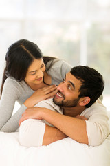 Fototapeta premium indian couple lying on bed at home