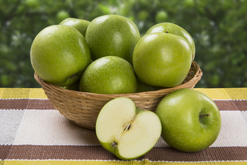 Some green apples on a wooden table