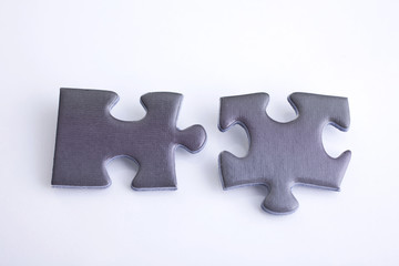 Fototapeta premium Jigsaw 2 pieces close-up shot from above on a white background