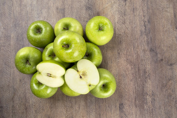 Some green apples on a wooden table