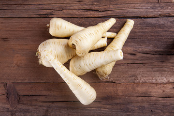 Parsnip bunch shot on a wooden background from above