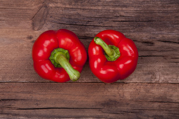 peppers two 2 shot on a wooden background from above