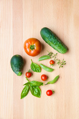 Mix of vegetables on wooden background - summer garden harvest.