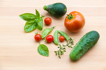 Mix of vegetables on wooden background - summer garden harvest.
