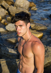 Fototapeta premium Muscular young man shirtless at sea