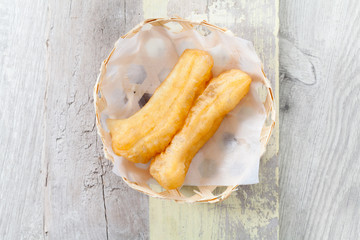 Deep fried traditional Thai dough stick in bamboo basket