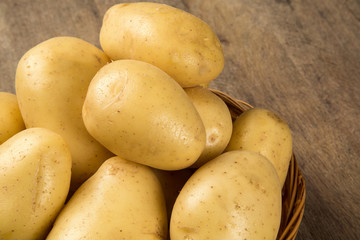 Some potatoes over a wooden surface