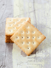 Stack of square crackers on wooden table