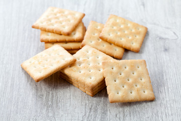 Stack of square crackers on wooden table