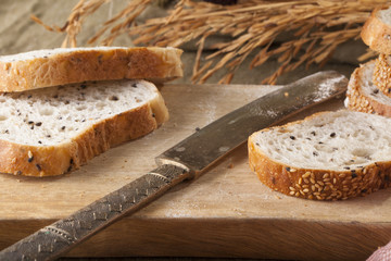 Bread, a set of variation of breads on a wood chopping block with spike