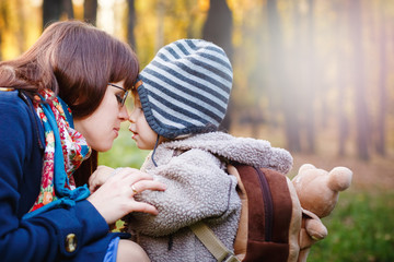 Obraz premium Young Happy Mother with Son Walking in the Park
