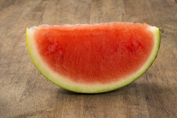 Fototapeta na wymiar slices of watermelon on wooden table