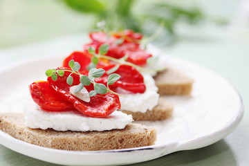 Canapes of cheese with sun-dried tomatoes