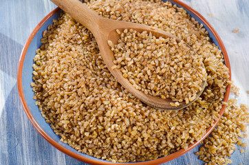 Bulgur on a  blue plate.