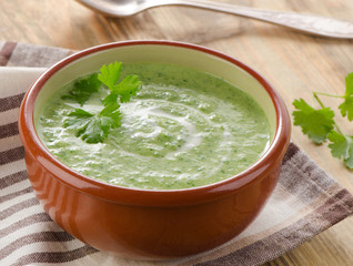 Creamy vegetable soup on a wooden table.