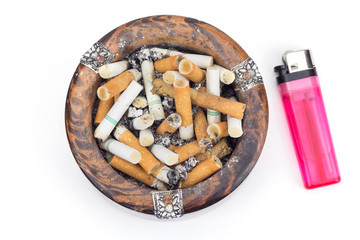 Butt cigarettes in wooden ashtray and lighter