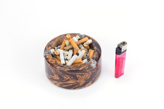 Butt cigarettes in wooden ashtray and lighter