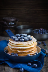 pancakes with blueberry and powdered sugar in pan © anna_shepulova