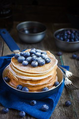pancakes with blueberry and powdered sugar in pan