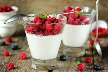 Summer cream dessert panna cotta with fresh berries in a glass