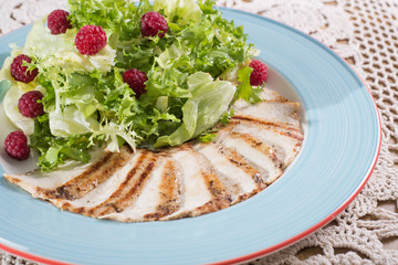 chicken fillet slices and raspberry in lettuce