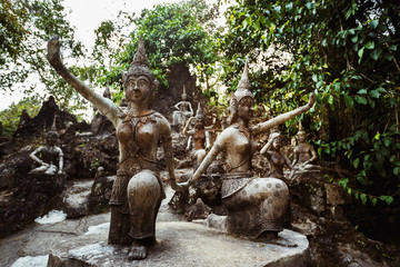 Fototapeta na wymiar Row of old statues in secret buddhist garden