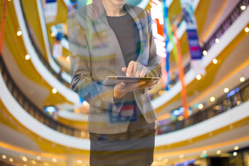 Fototapeta na wymiar Businesswoman using digital tablet in the shopping mall.