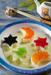 sushi roll with rice, flying fish caviar, salmon caviar. funny kids food. children japanese menu