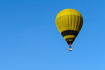 yellow hot air balloon in blue sky