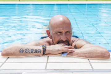 hipster man relaxes by the pool