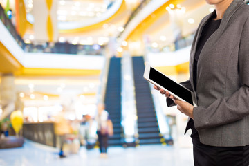 Businesswoman using digital tablet in the shopping mall.