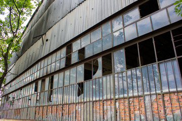 old industrial building structure/industrial warehouse abandoned and deserted with broken windowpane