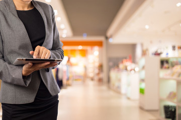 Businesswoman using digital tablet in the shopping mall.