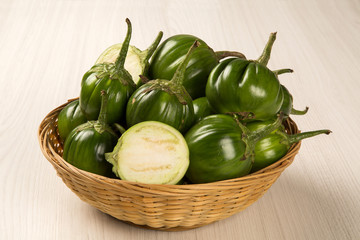 Some green african eggplants over a white background