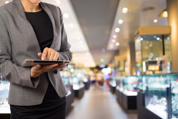 Businesswoman using digital tablet in the shopping mall.