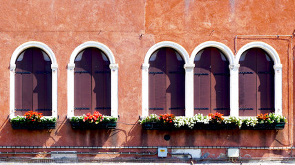 five wooden windows and ancient decay wall