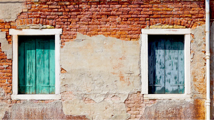 two windows and ancient decay brick wall