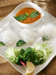 Rice noodles with herbs and sauce of curry and coconut milk. Thai cuisine
