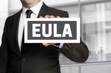 EULA sign is held by businessman background