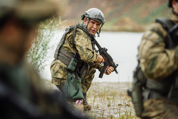 Portrait of a ranger in the battlefield with a gun