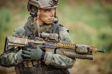 Portrait of a ranger in the battlefield with a gun