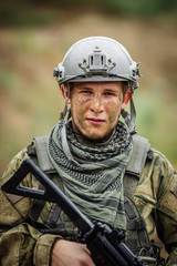 Fototapeta premium Portrait of a ranger in the battlefield with a gun