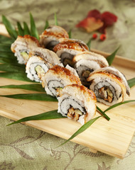 maki sushi with eel fish on wooden board. double unagi sushi