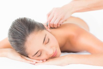 Obraz na płótnie Canvas Beautiful brunette enjoying a hot stone massage 