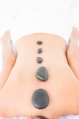 Obraz na płótnie Canvas Woman enjoying a hot stone massage 