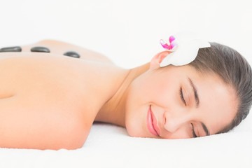 Obraz na płótnie Canvas Pretty woman enjoying a hot stone massage