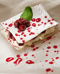 dessert with cherry, mille feuille with whipped sour cream. filo cake with drunk cherries