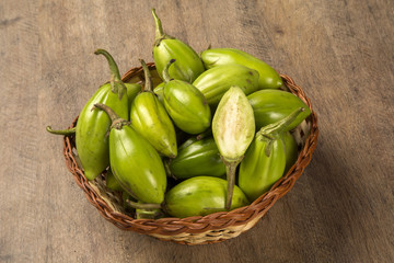 Some green african eggplants over a wooden surface