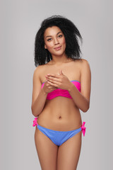 Fototapeta premium Smiling woman in swimsuit with cell phone